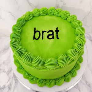 Neon green birthday cake with the word "Brat" written on it in black