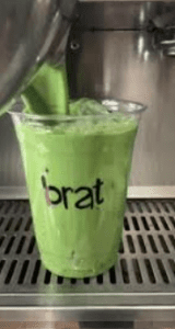 Iced Matcha with the word "brat" on the cup